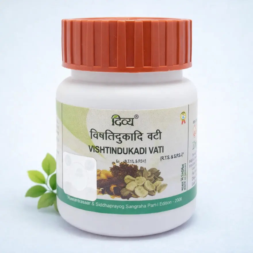 Divya Vishtindukadi Vati tablets for digestive support, white bottle with orange cap on light blue background